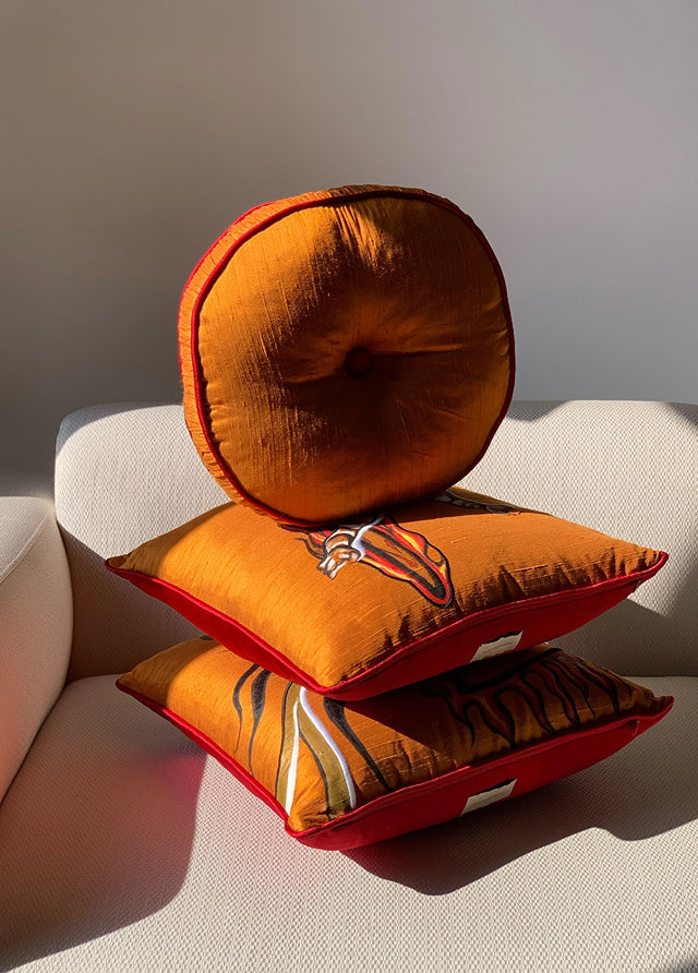 ALPAQ STUDIO. LUXURIOUS ROUND SILK CUSHION IN AMBER